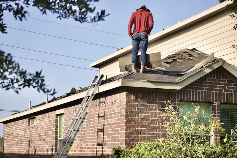 Professional roofer working on a residential roof in Warfield Estates